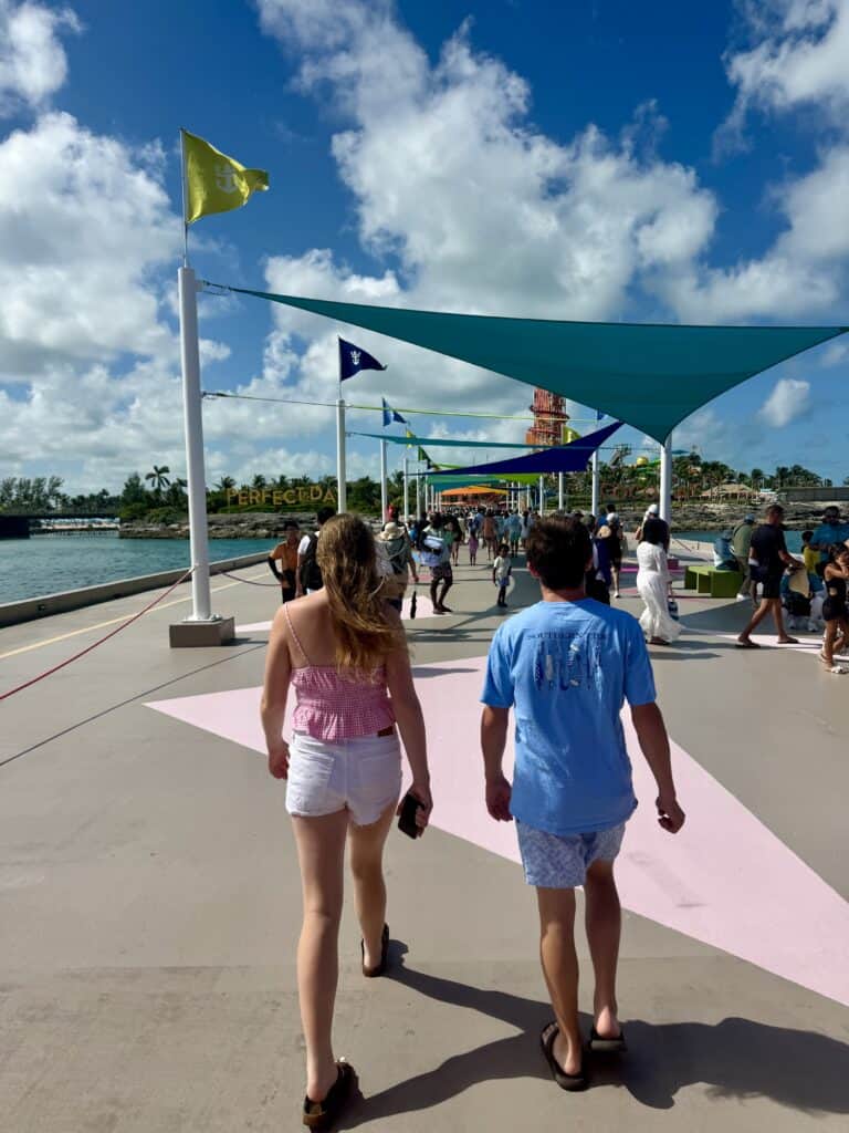 Two teenagers walking at Perfect Day at CocoCay during a Royal Caribbean mega cruise ship vacation